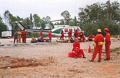 Helitack 140, a Bell 205A-1 and Ontario Ministry of Natural Resources firefighters working on Fire 141 in 1995