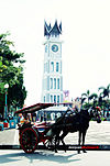 A horse cart (bendi) with background of Jam Gadang, an icon of Bukittinggi