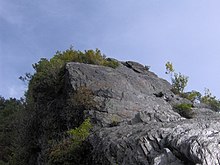Folded metamorphic rock characterizes the capstones of Chimney Tops.
