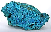 Powder-blue chrysocolla as stalactitic growths and as a thin carpet in vugs inside a boulder of nearly solid tyrolite from the San Simon Mine, Iquique Province, Chile (size: 14.1 x 8.0 x 7.8 cm)