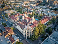 Aerial photograph of the Mission Inn–a four story Spanish revival structure with red tile roofs.
