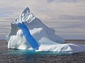 Iceberg off the Greenland coast with crevasse filled with frozen meltwater