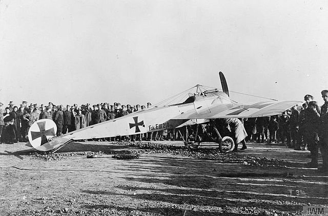 A Fokker E.III draws a crowd of curious soldiers.