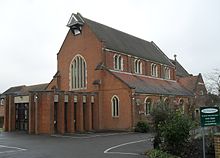 The borough's Victorian and Edwardian growth was served by churches such as Holy Trinity at Redhill (1906; porch added 1967). Holy Trinity Church, London Road, Redhill (January 2011).JPG