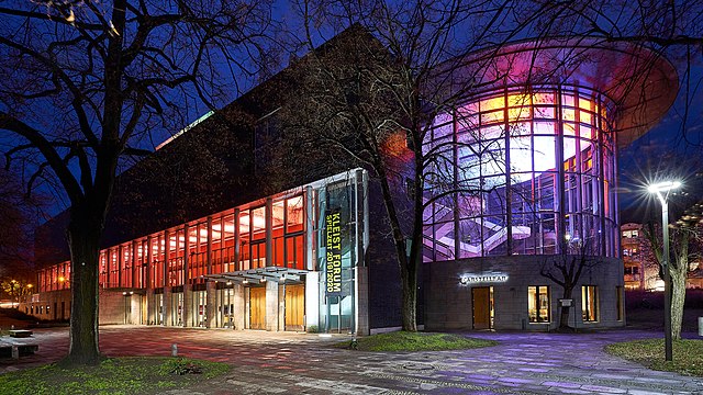 Außenansicht des Kleist Forums Frankfurt (Oder) am Abend mit beleuchtetem Foyer