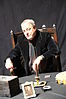 Mark Edward seated at a seance table