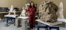 Photo of Meekyoung Shin standing next of some of her sculptures.