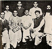 A group photo of people accused in Gandhi's murder case. Standing: Shankar Kistaiya, Gopal Godse, Madanlal Pahwa, Digambar Badge (Approver). Sitting: Narayan Apte, Vinayak D. Savarkar, Nathuram Godse, Vishnu Karkare