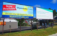 Outfront Media billboards in Wyandotte, Michigan, advertising Wyandotte Municipal Services's cable television service and Citizens Bank Outfront billboards Wyandotte MI.jpg