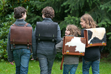 Children carrying leather and cowhide satchels in Germany