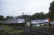 A special train celebrating the return of the Montrealer poses with a ceremonial barrier at Amherst station on July 17, 1989, the day before regular service began Special train for resumed Montrealer at Amherst, July 17, 1989.jpg