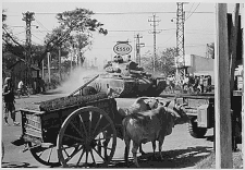 Tank from 1st Battalion, 69th Armor, 25th Infantry Division, moves through Saigon shortly after disembarking from LST at Saigon Harbor, 12 March 1966 Tank-saigon.gif