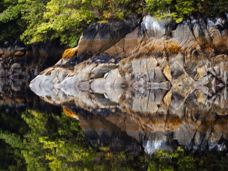 File:Tidal rocks of Hevenor Inlet reflected in a calm sea.webp