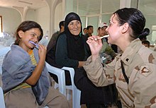 A child being shown how to use a toothbrush. Toothbrush teaching 1.jpg