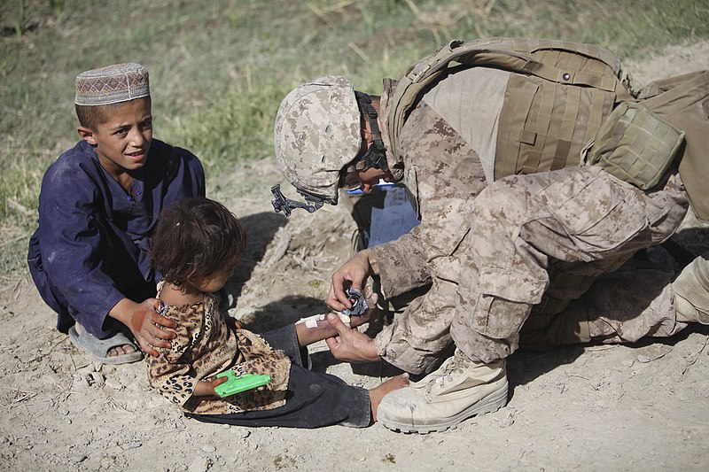 File:US Navy 090717-M-0440G-087 Hospital Corpsman 2nd Class Brian Sandau treats an Afghan girl for burns on her leg during a civil affairs group patrol.jpg