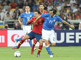 Pirlo disputando el balón con Xavi Hernández en la final de la Eurocopa 2012. El centrocampista español confesó ser un gran admirador del estilo de juego del italiano.[242]