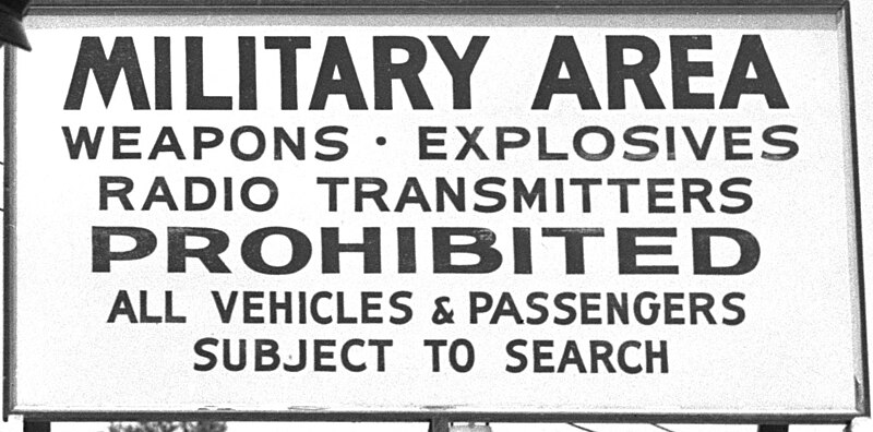 File:"MILITARY AREA" "WEAPONS EXPLOSIVES RADIO TRANSMITTERS PROHIBITED" "ALL VEHICLES & PASSENGERS SUBJECT TO SEARCH" sign detail, Atomic Energy Commission Patrol Solway GateOak Ridge 1947 (26472112879) (cropped).jpg