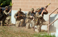 Troops from 3rd battalion, Princess of Wales Royal Regiment practice breach and clear operations at Camp Grayling Joint Maneuver Training