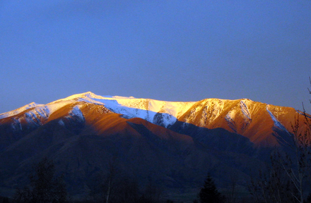 View of southwestern side of the Benmore Range, South Island, New Zealand, at sunset, from Omarama village. Benmore Peak is the highest point at left of centre. Benmore Peak Sunset.png