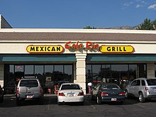 A restaurant in Provo, Utah with the sign "Cafe Rio Mexican Grill" on its storefront