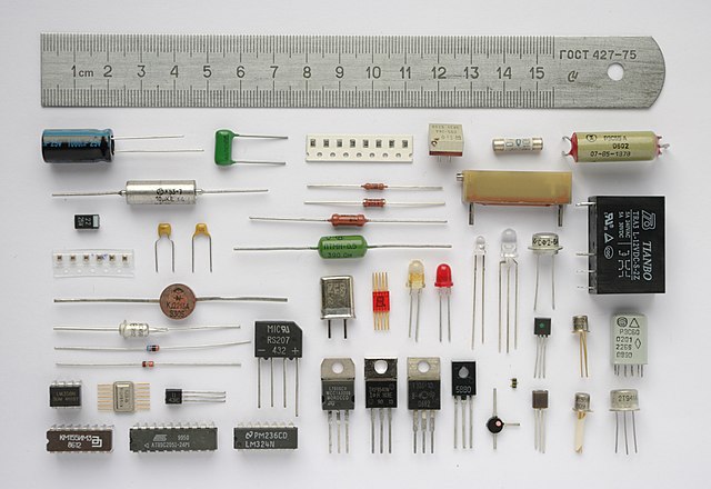 Various electronic components, with a 15 cm ruler to scale.