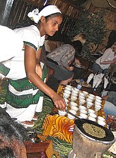 An Ethiopian woman preparing Ethiopian coffee at a traditional ceremony. She roasts, crushes, and brews the coffee on the spot. Ethcofcerm.jpg