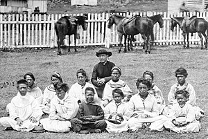 Father Damien with the Kalawao Girls Choir, at Kalaupapa, Molokai, circa 1878.jpg