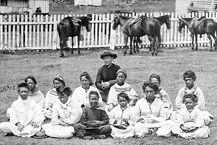 Father Damien, seen here with the Kalawao Girls Choir during the 1870s.