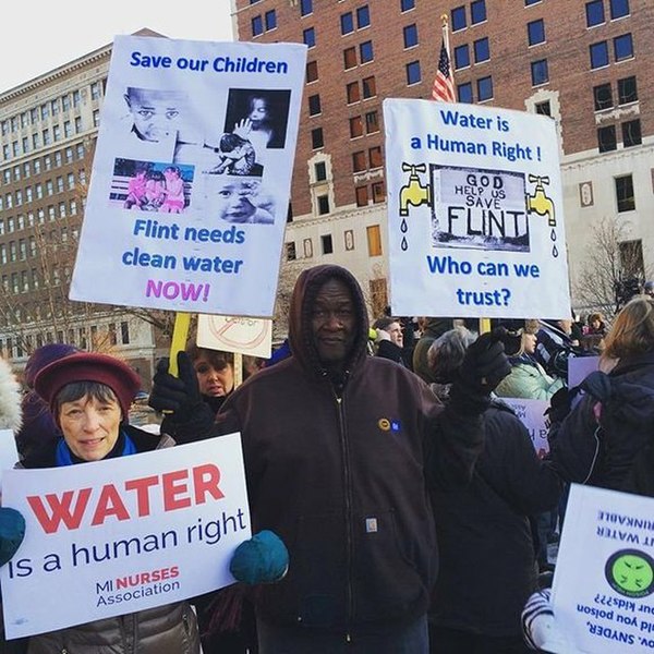 People protesting the water crisis in Flint, Michigan, which disproportionately affected people of color and low-income communities