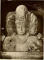 A 1913 image of the Trimurti located at the Elephanta Caves, a UNESCO heritage site Hindu Trinity Elephanta Caves India 1913.jpg