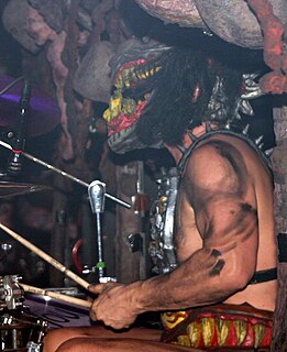 Jizmak Da Gusha is the drummer for the heavy metal band Gwar. Although the costume has undergone many changes since the character was introduced, Jizmak's onstage get-up somewhat resembles a monstrous dog with very large teeth. He is usually seen wielding a large warhammer, most likely a reference to his role as drummer in the band.