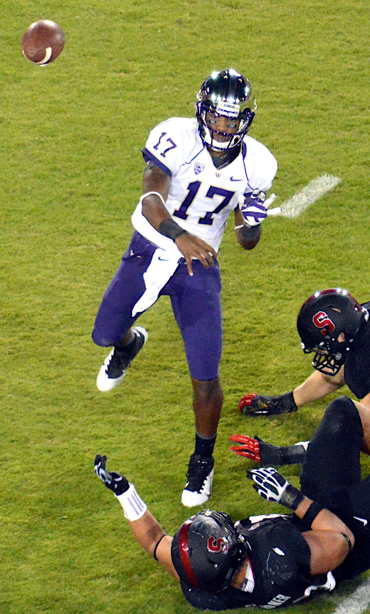 Washington quarterback Keith Price smiles as players greet each other after  the team beat Arizona in