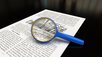 Magnifying glass with focus on paper.png