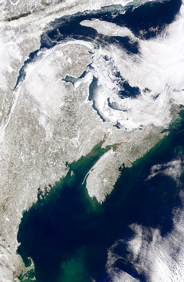 The Maritime Peninsula from space, with cloud banks along coastal areas and snow and ice covering the interior