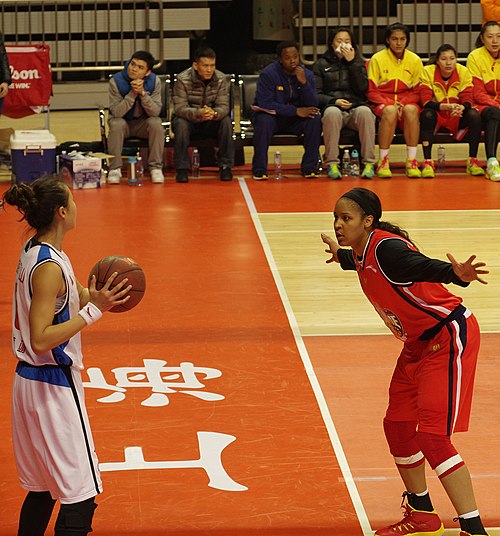 Shanxi Flame's Maya Moore defending an inbound pass from Shanghai Octopus's Huang Jing during a January 2014 WCBA game in Shanghai.