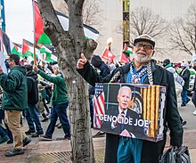 A protestor in Columbus, Ohio, carrying a sign referring to Biden as "Genocide Joe." Palestinian genocide accusation (53415402353).jpg