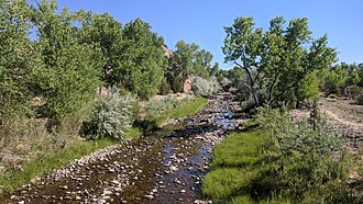 View of the Rio Ojo Caliente looking upstream from the bridge on the Ojo Caliente Mineral Springs Resort and Spa's bosque loop trail Rio Ojo Caliente.jpg