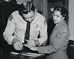 Rosa Parks being fingerprinted by Deputy Sheriff D.H. Lackey after being arrested on February 22, 1956, during the Montgomery bus boycott.jpg