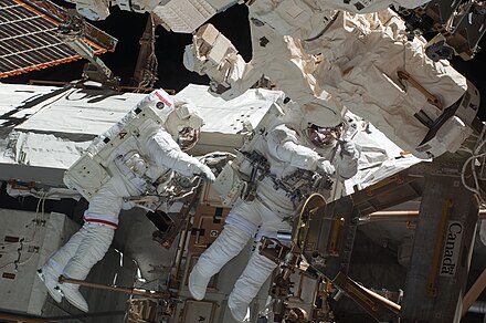 Astronauts Behnken and Patrick participate in the first spacewalk.