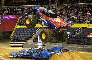 Monster truck vehicle typically styled after pickup truck bodies, modified or purposely built with extremely large wheels and suspension