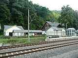 Waiting room, bicycle rack and underpass next to the station building