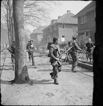 Infantrymen of the 11th Battalion, Royal Scots Fusiliers, 49th (West Riding) Division, searching houses in Ede in the Netherlands, 17 April 1945. The British Army in North-west Europe 1944-45 BU4217.jpg