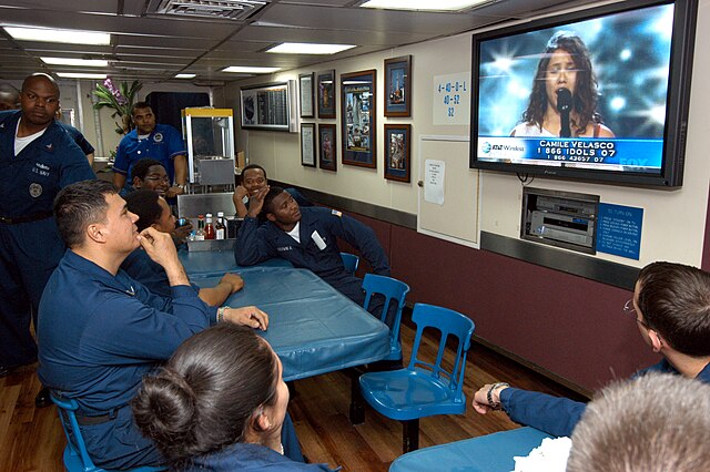 Aboard USS Blue Ridge, Machinist's Mate 1st Class William Velasco watches his daughter Camile Velasco perform.