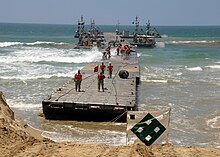 Army and Navy personnel constructing a JLOTS floating pier in 2008 US Navy 080721-N-1424C-317 The Army Trident pier approaches Gold Beach during Joint Logistics Over-The-Shore (JLOTS) 2008.jpg