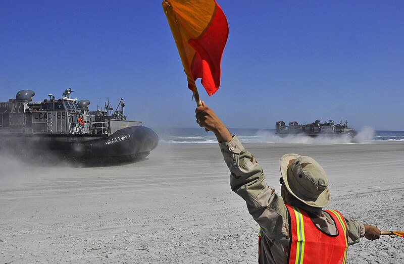 File:US Navy 090424-G-6464J-014 A landing signal officer assigned to Beachmaster Unit 2 directs landing craft air cushioned vehicles from Assault Craft Unit (ACU) 4 to their landing zones to disembark soldiers and marines.jpg