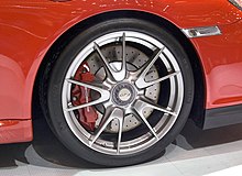 A modern centerlock wheel mounted on a 2009 Porsche 997 GT3, with Porsche-specific fastener 2009 997 GT3 19-inch wheel with central locking device.jpg