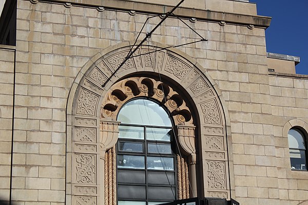 Detail of main entrance arch. In the intrados of the arch are half-menorahs. Above those, seven Moorish-style openings with medallions are arranged in