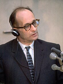 Ο Άντολφ Άιχμαν μπροστά από μικρόφωνα, στη δίκη του.