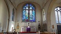 View of the altar and west stained glass window.