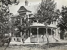 The Garver family poses with their newly completed house, 1887.